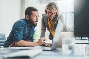 two people working on a computer